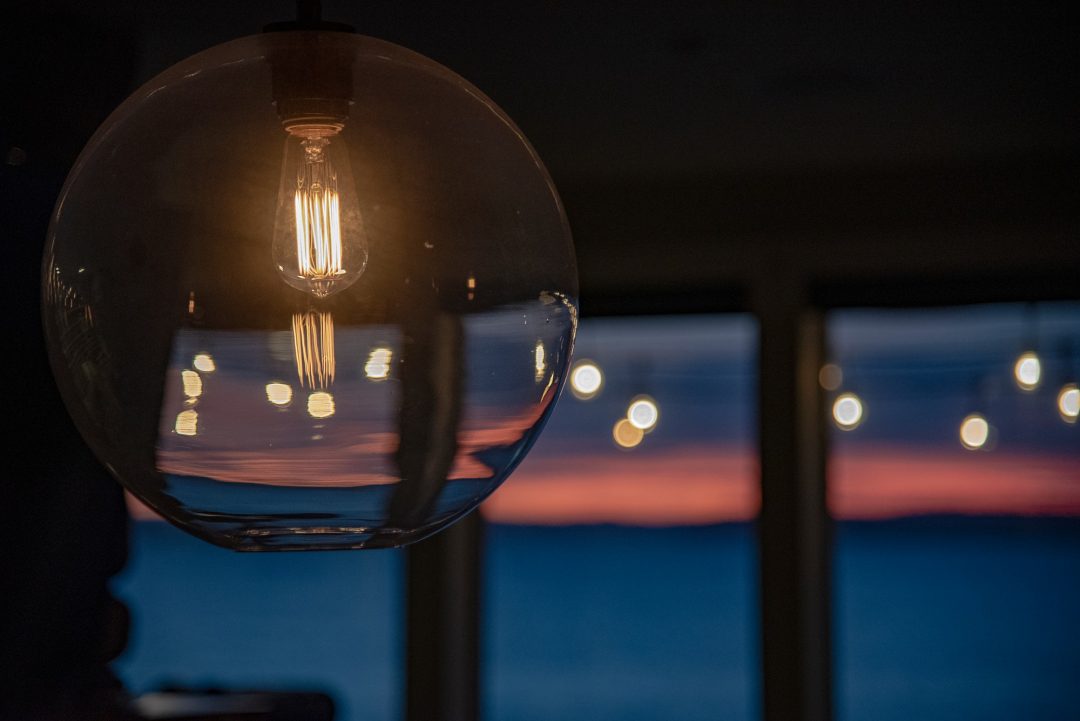 Warm lightbulb glowing in modern residential interior — restaurant and hospitality lighting design guide Bangladesh