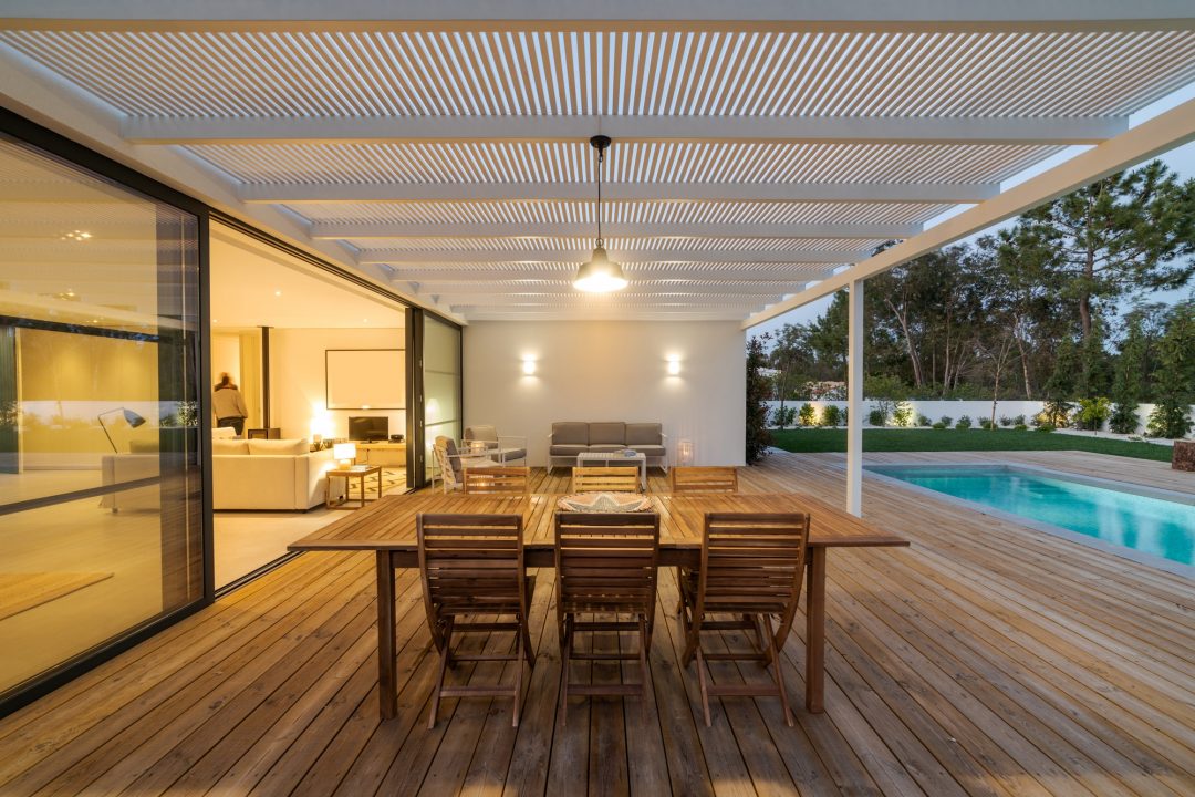 Modern house outdoor timber deck with pool, slatted ceiling, outdoor furniture and landscaped garden — flooring and outdoor design Bangladesh