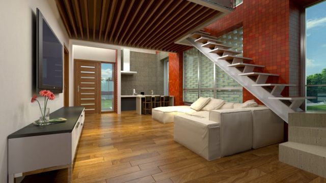 PKP Cottage living room — wide-plank timber floor, slatted timber batten ceiling with linear lighting, cream sectional sofa, floating open-tread steel staircase, red mosaic feature column and perforated screen wall, Bangladesh